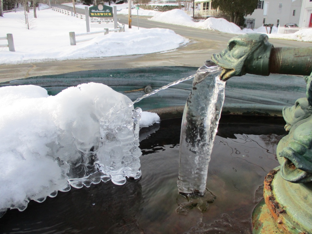 Water jetting out of the jug filler of Captain Ball's Fountain creating ice sculptures in the winter temperatures.